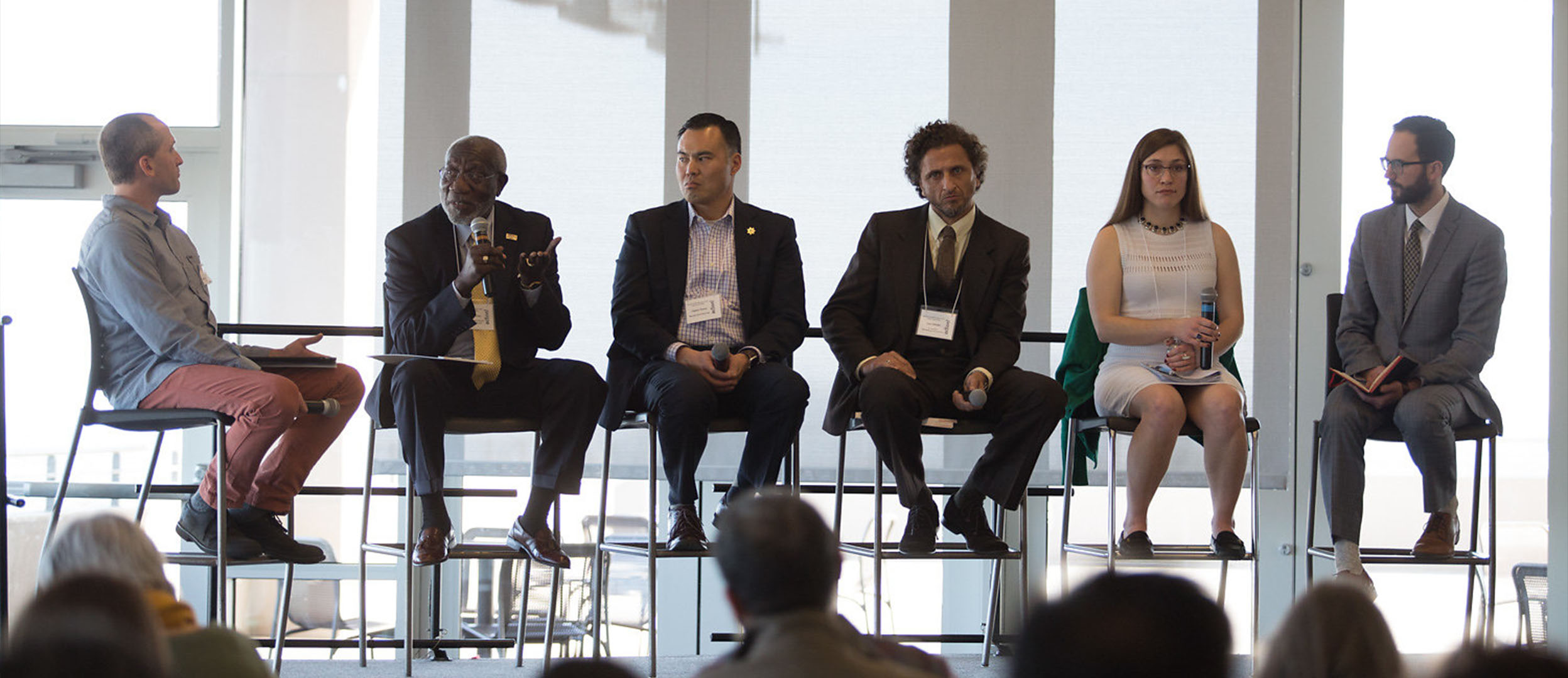 People speaking on a panel