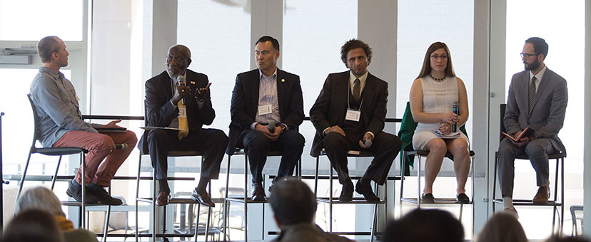 People speaking on a panel